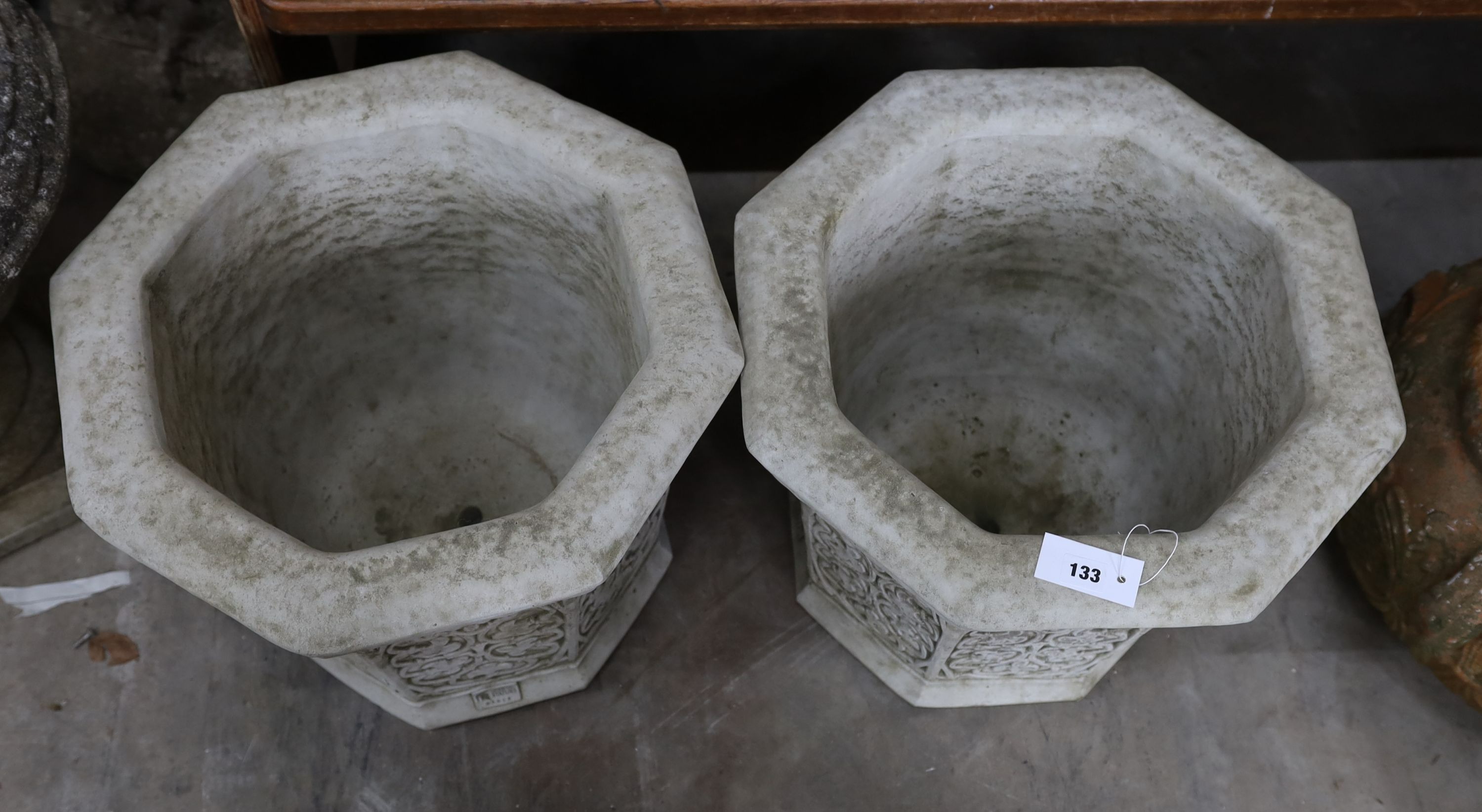 A pair of octagonal reconstituted stone garden planters, width 49cm, height 41cm